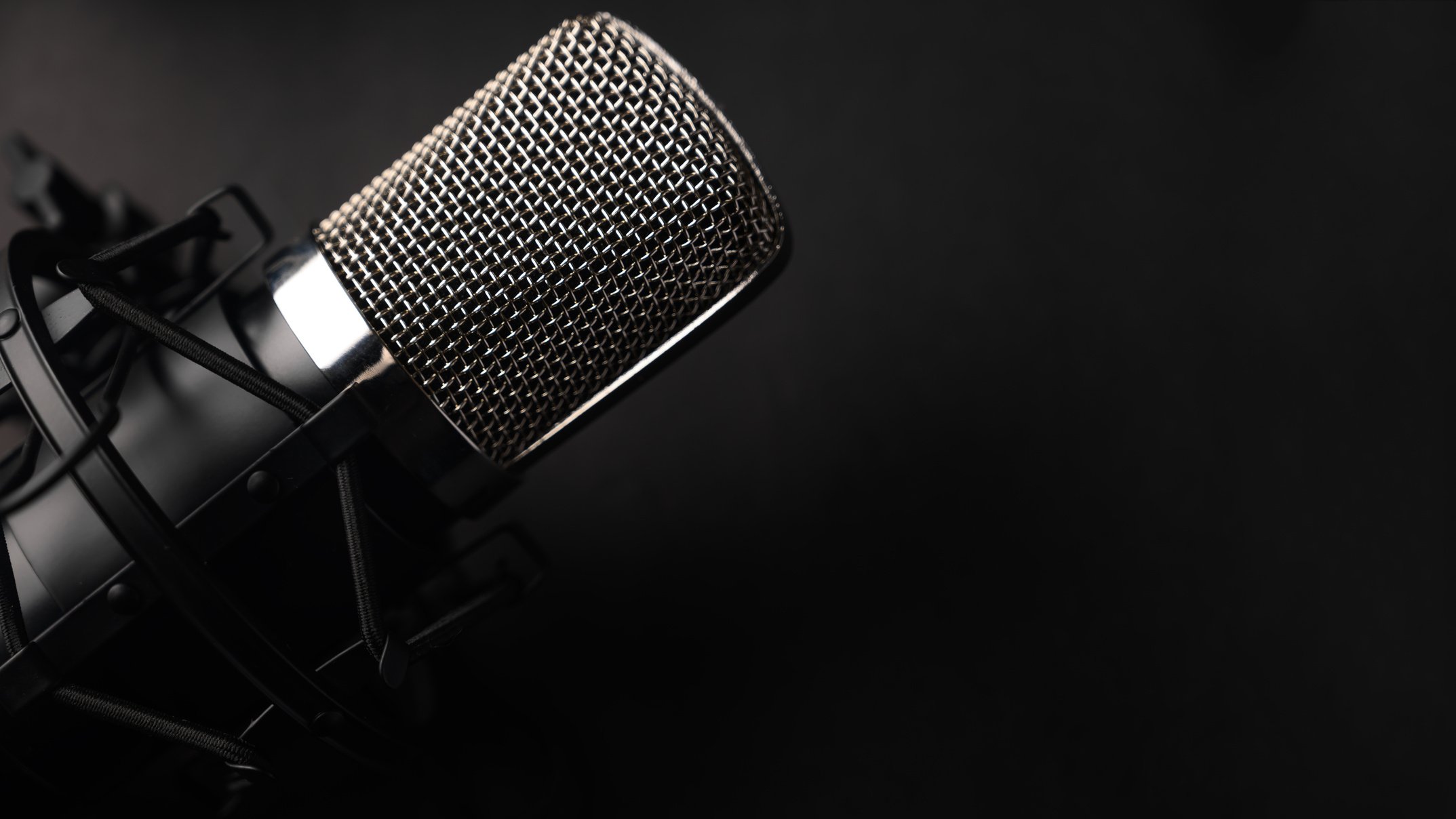 Condenser black studio microphone on a black background. Streamer, podcasts, music background